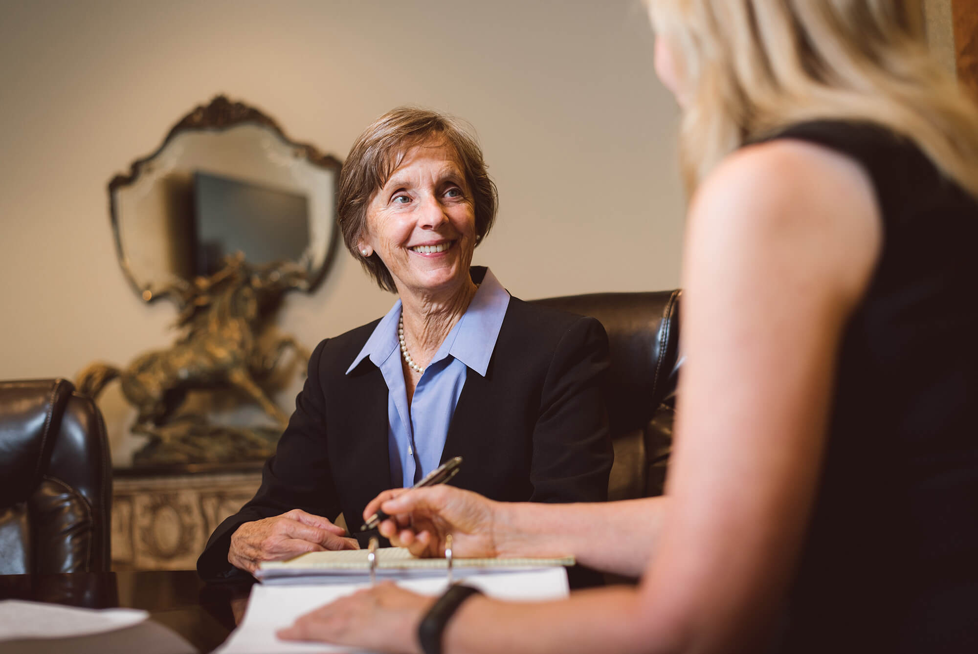 Allyson Hughes, Esq. Florida Board Certified Attorney, AAML meeting with a client at the Hughes Law Group offices.
