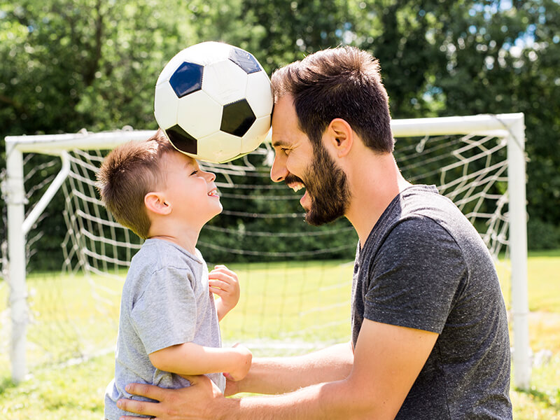 Father playing with child — Hughes Law Group