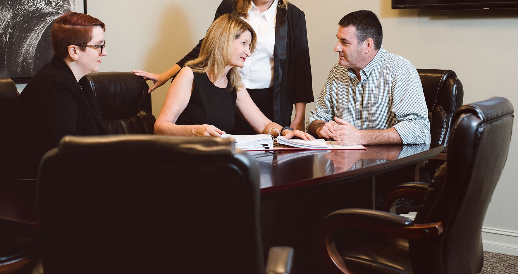 Allyson Hughes with client and staff at Hughes Law Group